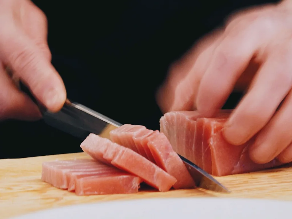 Chef slicing fresh tuna at Bloom Cuisine