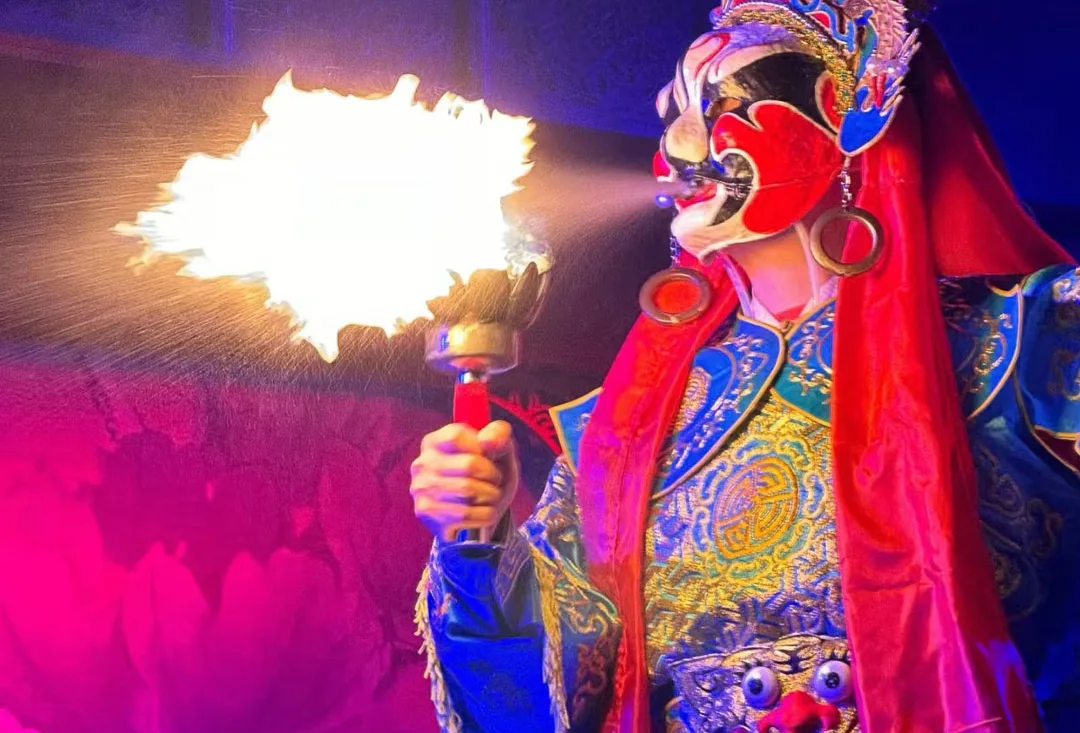 A Sichuan Opera performer breathing fire on stage
