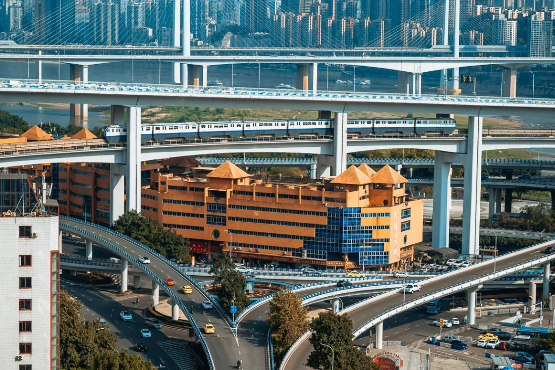 Roads and residential towers stacked across Chongqing's steep urban landscape