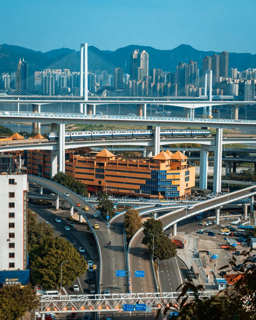 Roads and residential towers stacked across Chongqing's steep urban landscape