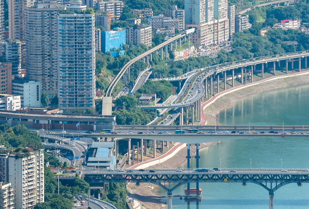 Bridges and hillside neighbourhoods lining a river valley in Chongqing