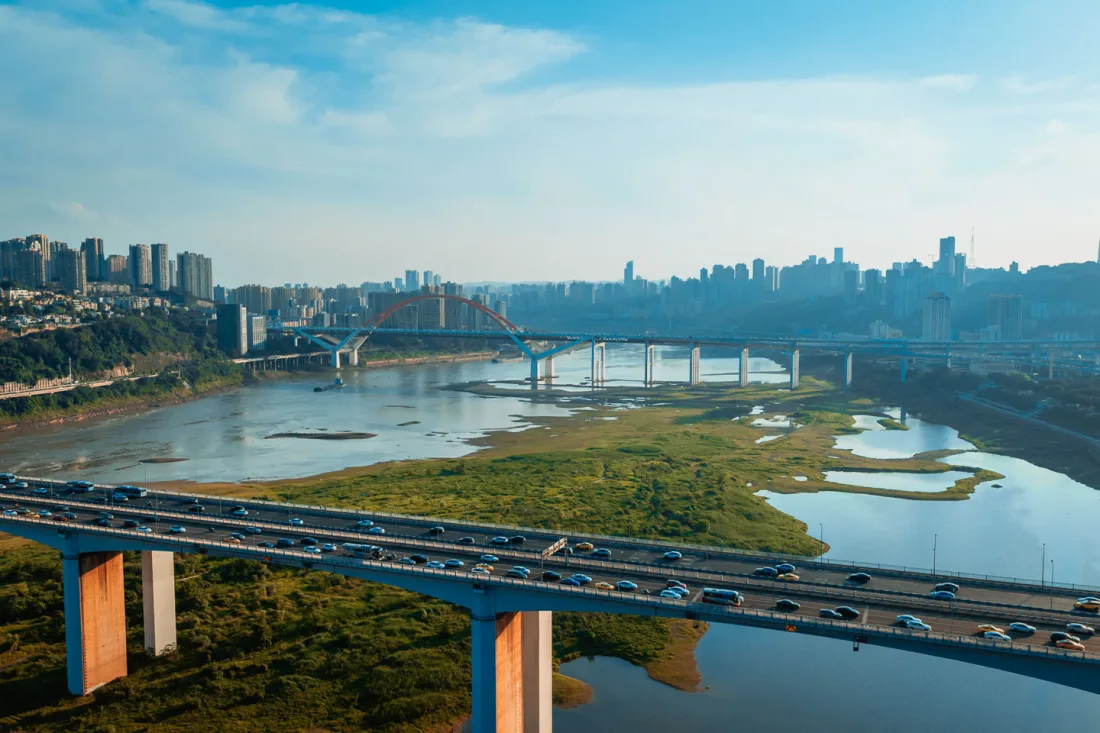 Wide river and bridges stretching across Chongqing in daylight