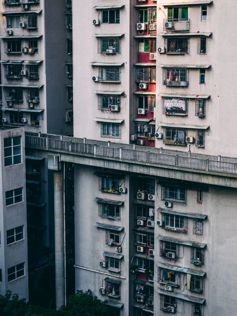 An elevated road passing directly between residential buildings in Chongqing