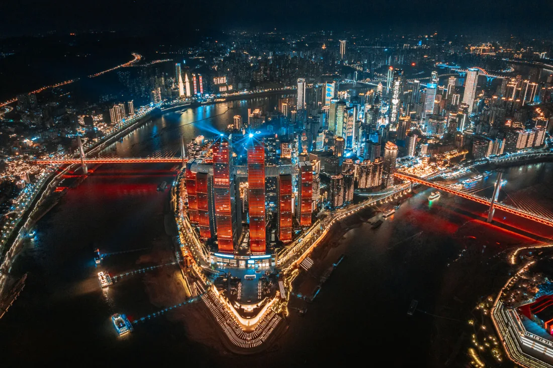 Aerial night view of Chongqing skyscrapers and riverfront lights