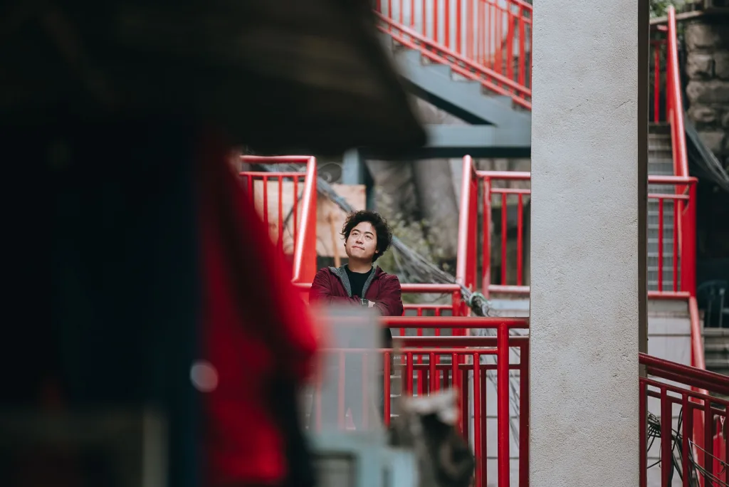 Jackson photographed among red walkways in a Chongqing residential building