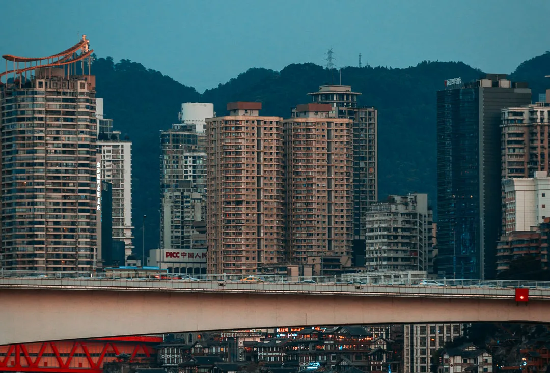 The moon rising above Hongya Cave and the Chongqing riverfront