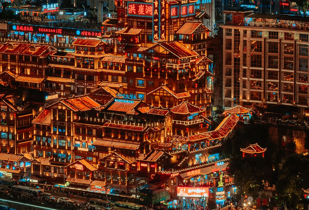 Hongya Cave illuminated beside the river in Chongqing at night