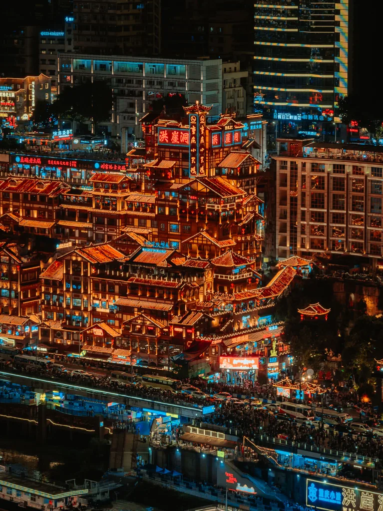 Hongya Cave illuminated beside the river in Chongqing at night