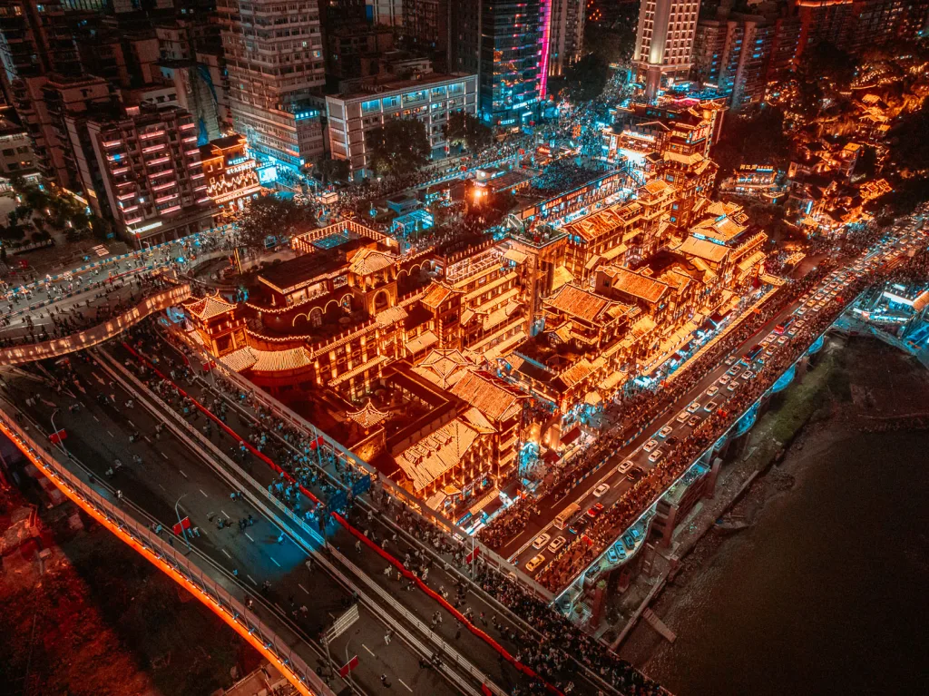 Hongya Cave illuminated beside the river in Chongqing at night