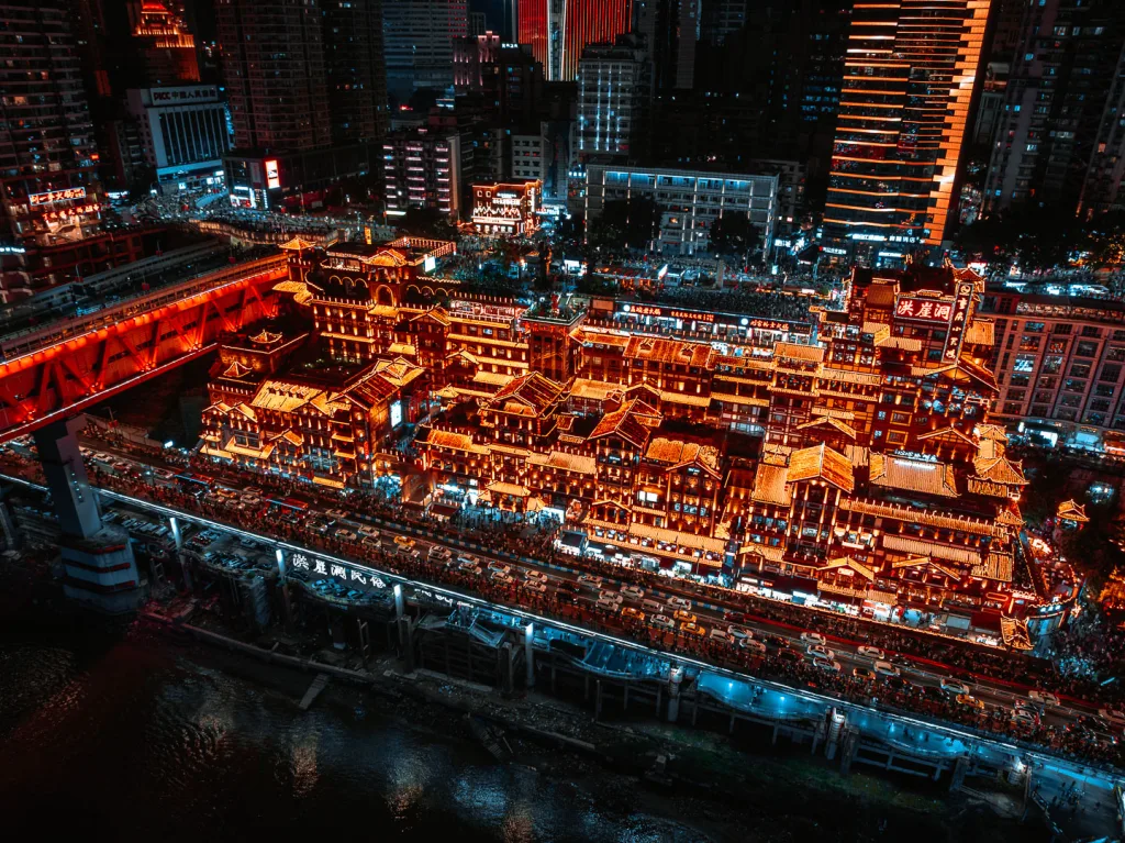 Hongya Cave illuminated beside the river in Chongqing at night