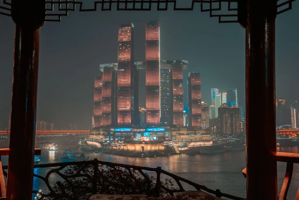 Chongqing river skyline framed by a pavilion in Huguishi Park