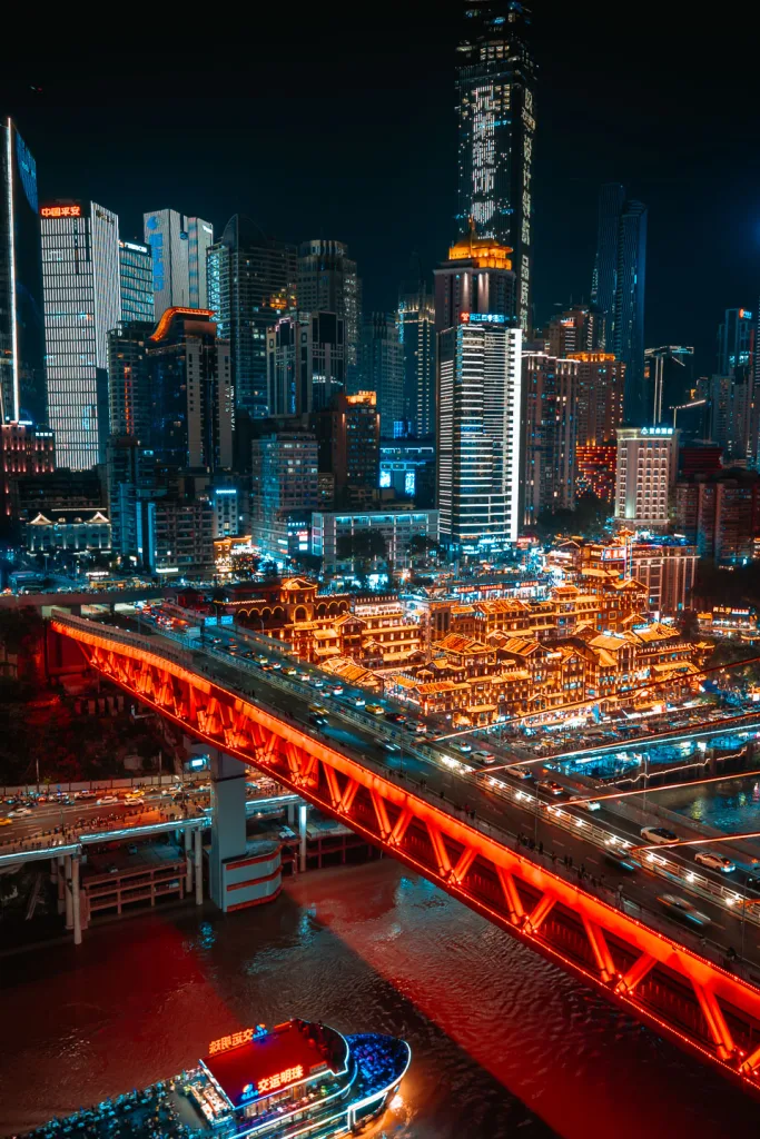 Qiansimen Bridge glowing red above Hongya Cave at night