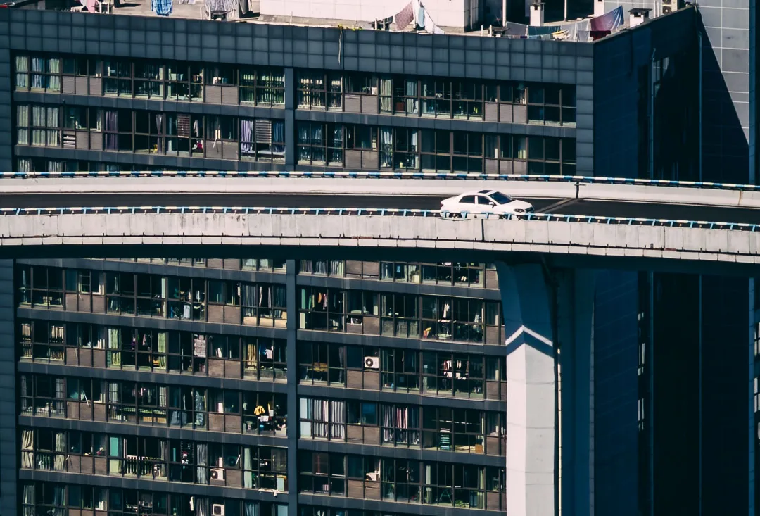 The circular Sujiaba interchange ramp rising above Chongqing
