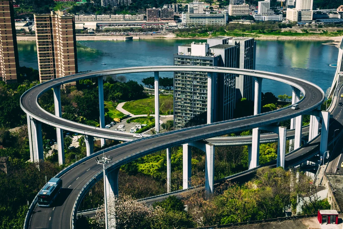 The circular Sujiaba interchange ramp rising above Chongqing