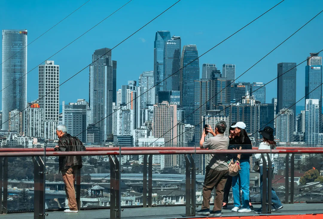 Visitors enjoying the elevated red walkway at Tongyuanzhiguang Sky Island
