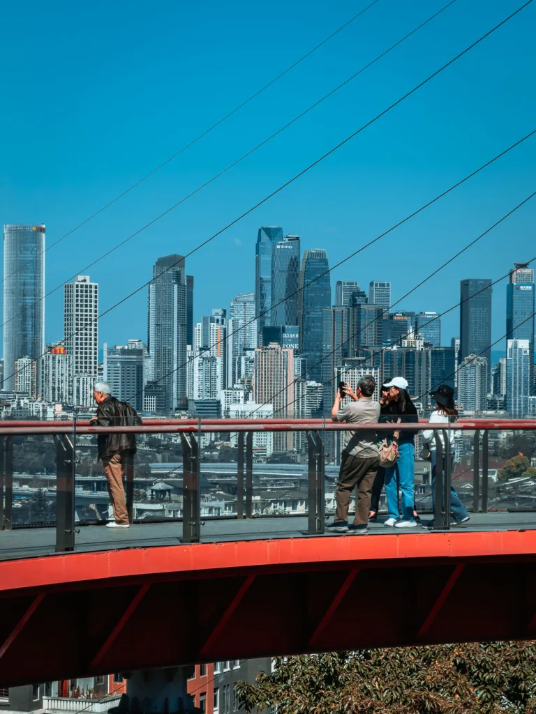 Visitors enjoying the elevated red walkway at Tongyuanzhiguang Sky Island