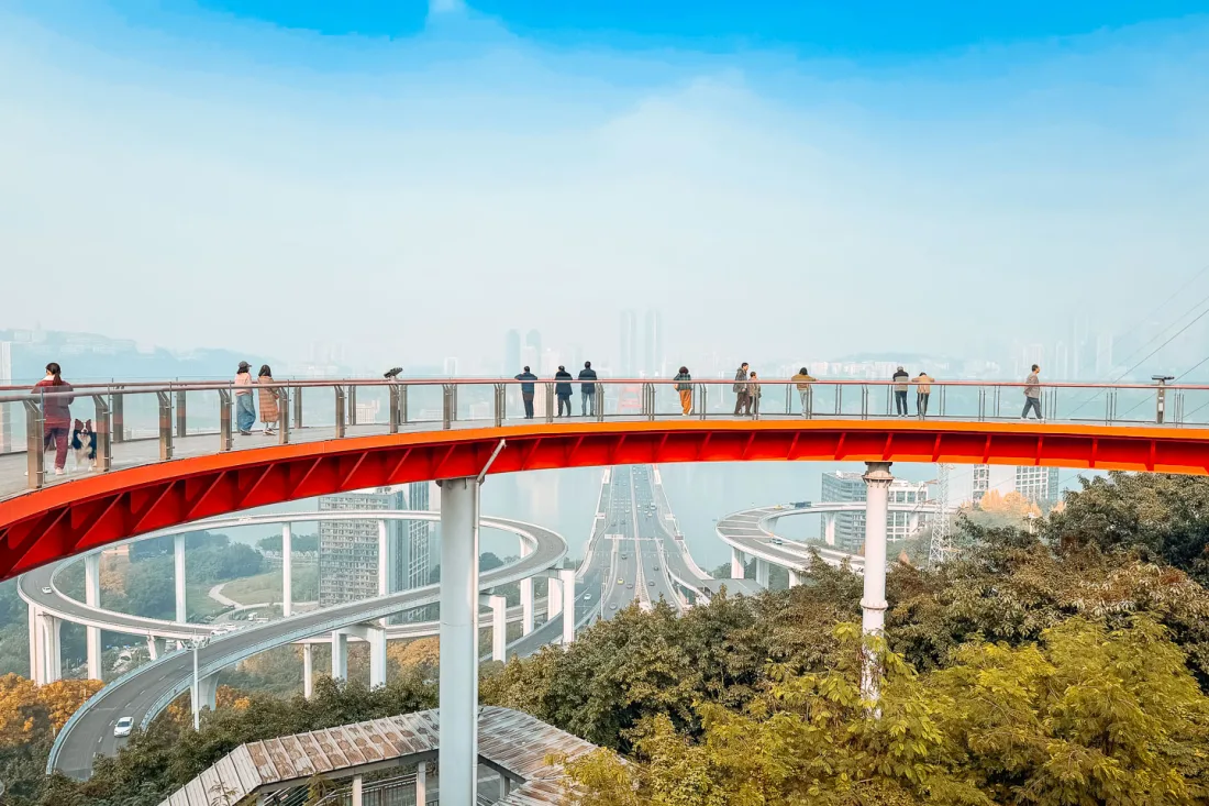 Visitors enjoying the elevated red walkway at Tongyuanzhiguang Sky Island