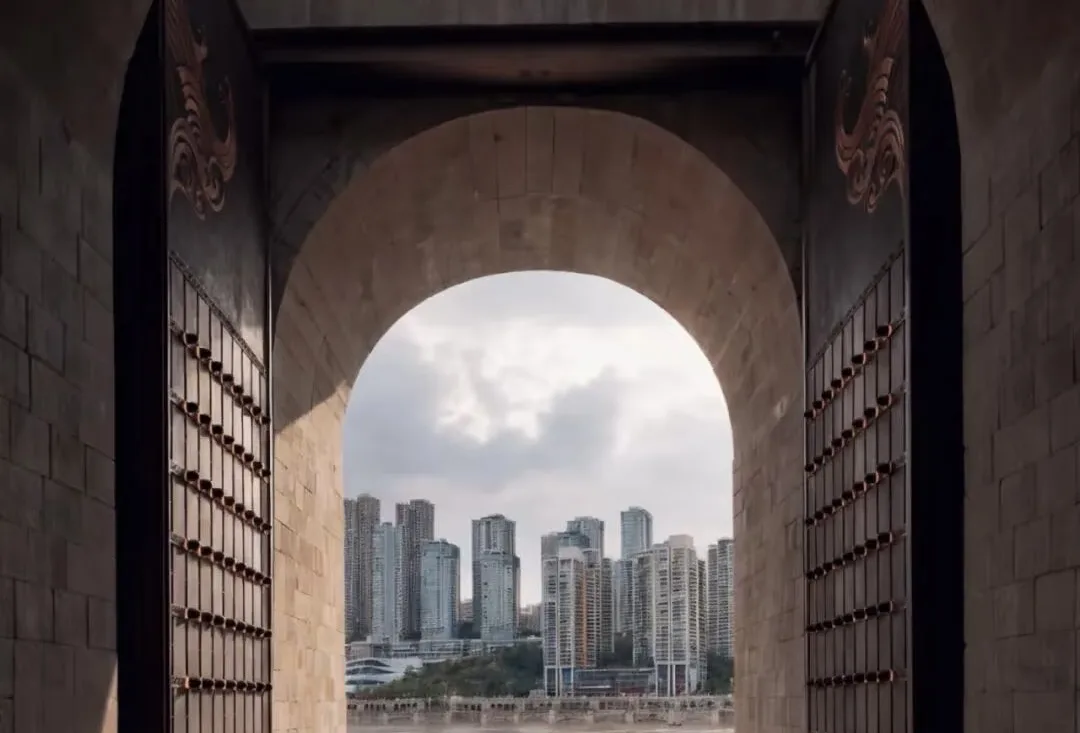 Modern Chongqing skyline framed by a historic gateway at Chaotianmen