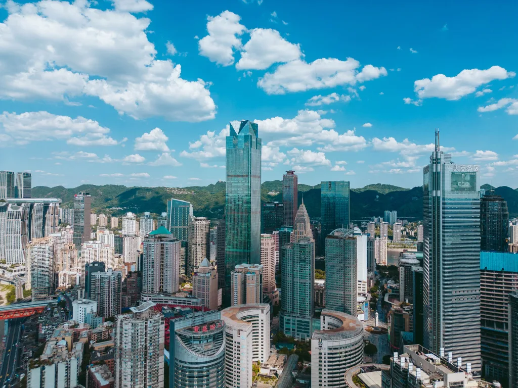 Central Chongqing skyline beneath vivid blue skies and clouds
