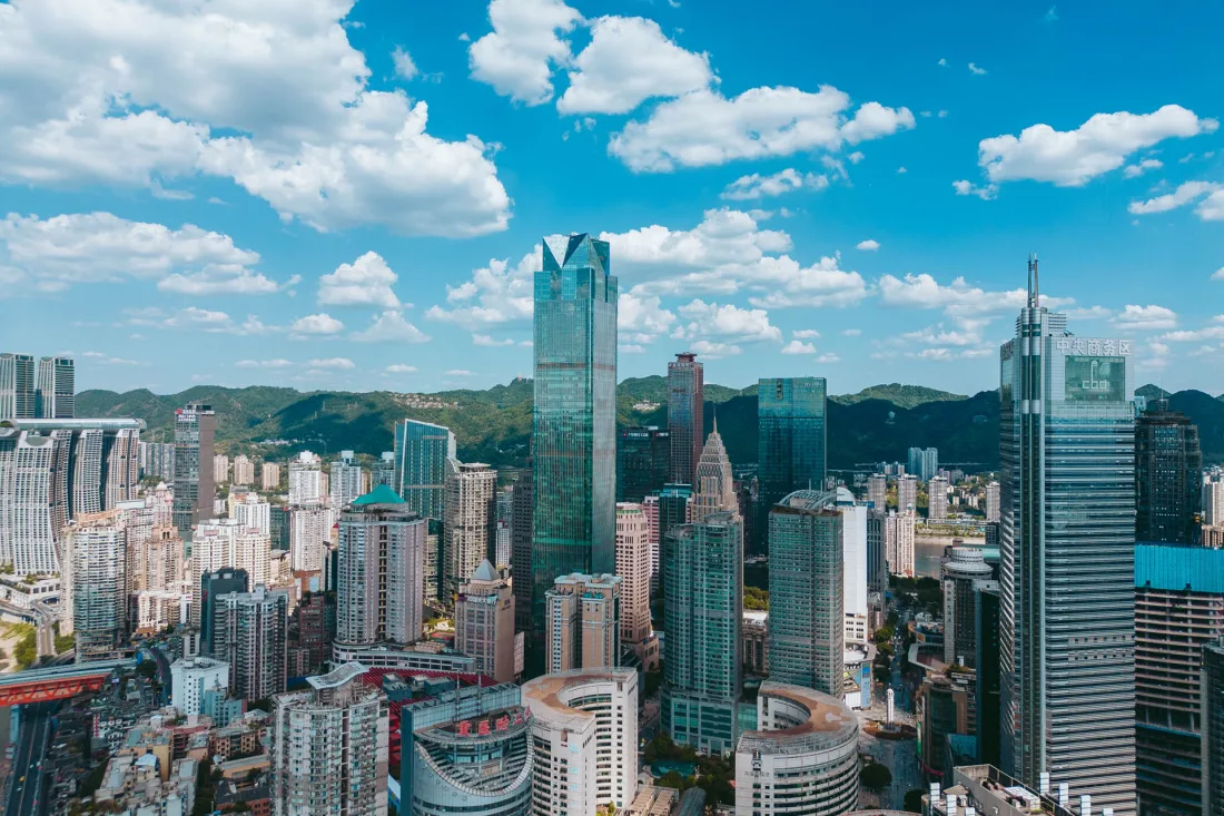 Central Chongqing skyline beneath vivid blue skies and clouds