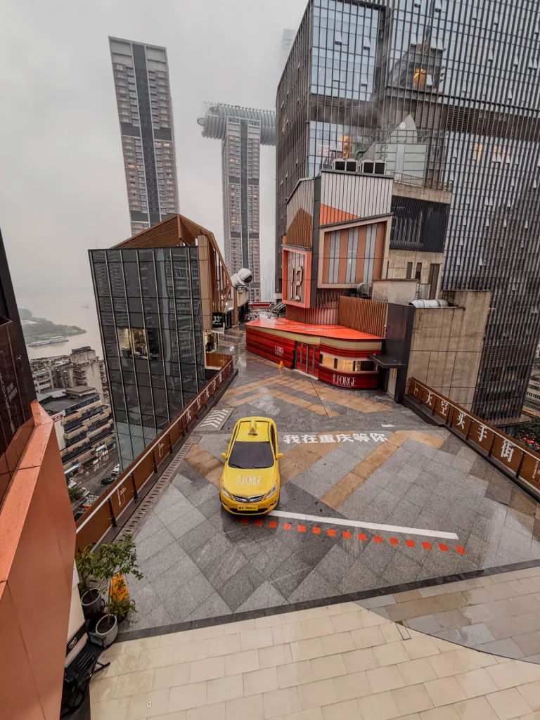Find a bright yellow Ferrari taxi unexpectedly parked on the rooftop of IMix Mall.
