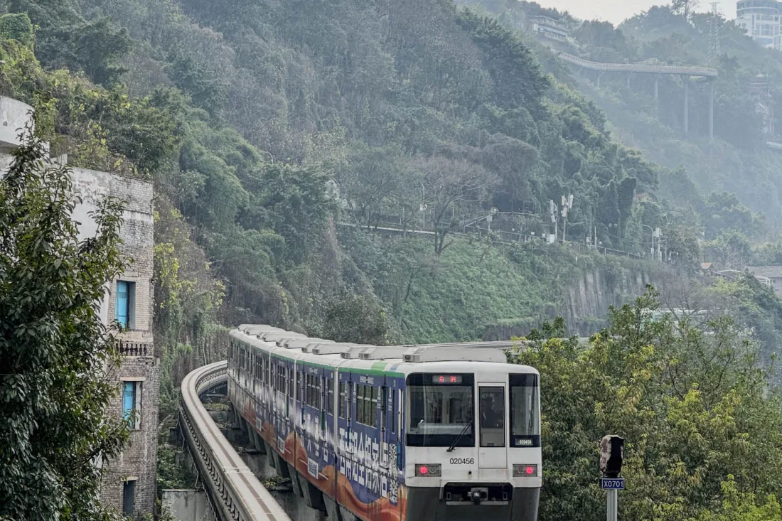 A Chongqing monorail train travelling along a mountain-side elevated track