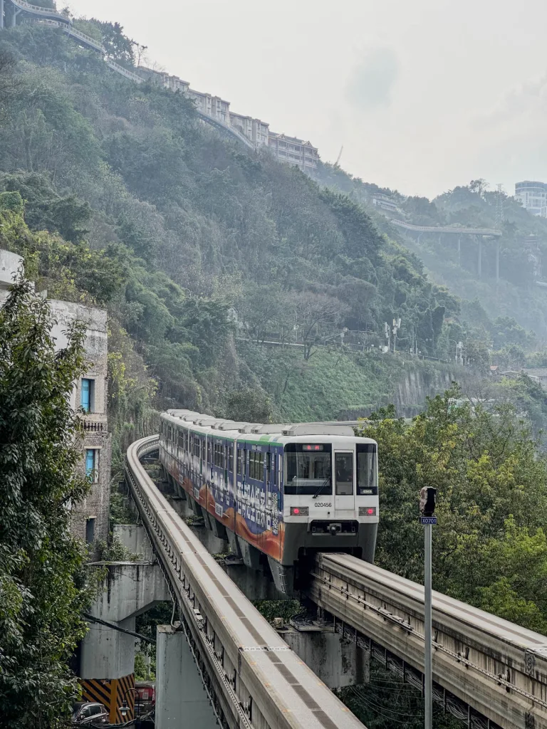 A Chongqing monorail train travelling along a mountain-side elevated track