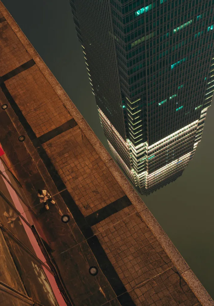 A traveller posing among Chongqing skyscrapers, neon lights and riverside night views