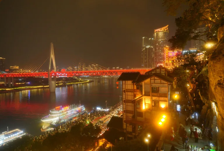 Watch neon signs, glowing buildings and illuminated riverbanks transform the layered skyline after dark.