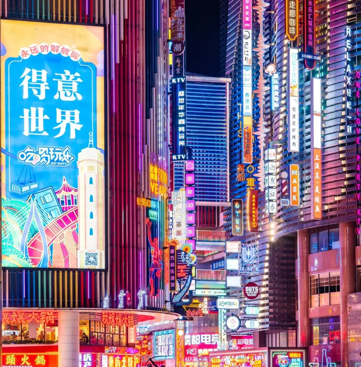 A traveller posing among Chongqing skyscrapers, neon lights and riverside night views