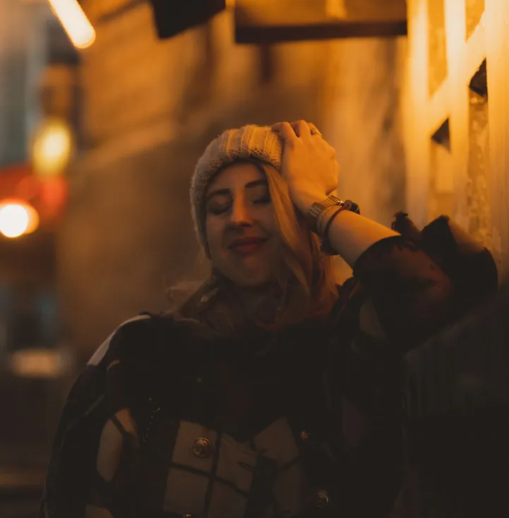 A traveller photographed beneath warm lights during a Chongqing night walk