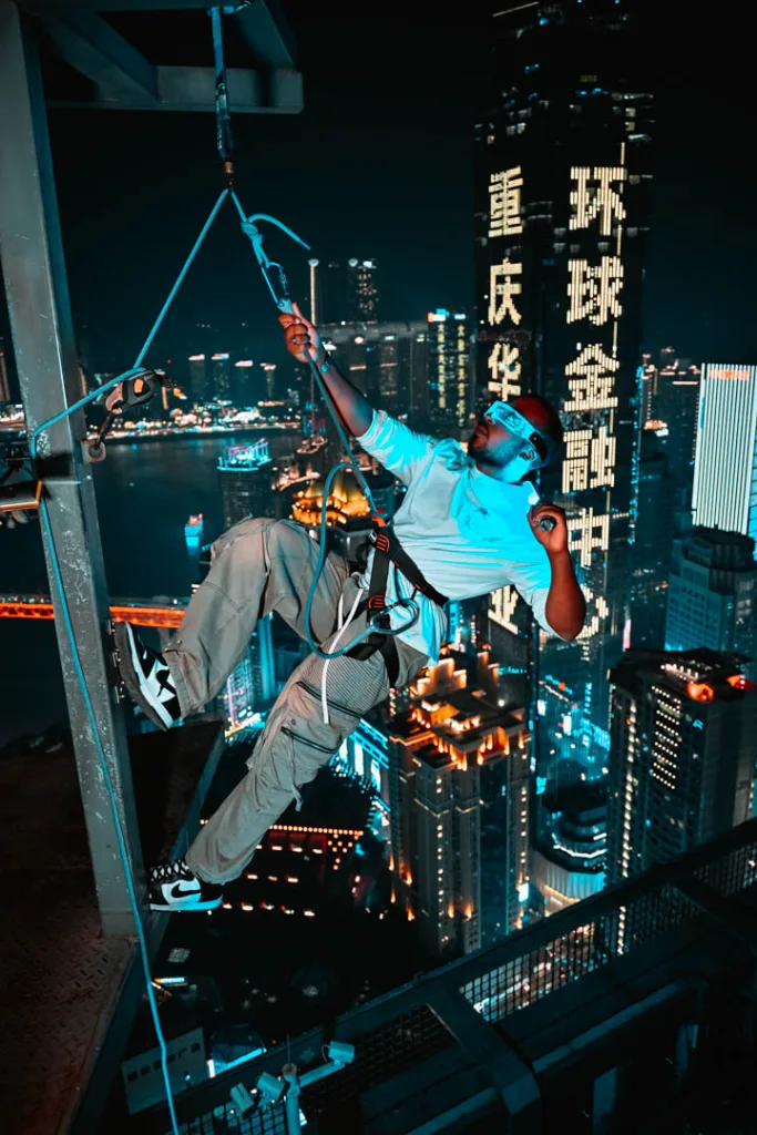 A traveller posing above the neon-lit streets of Chongqing at night