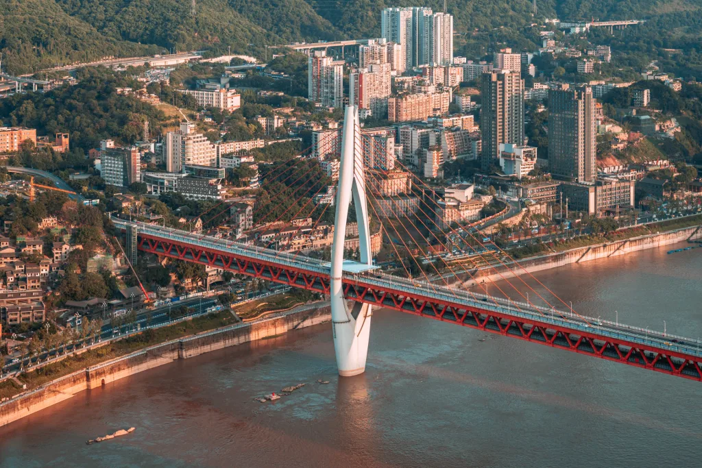 Aerial daytime view of Dongshuimen Bridge crossing the Yangtze River in Chongqing