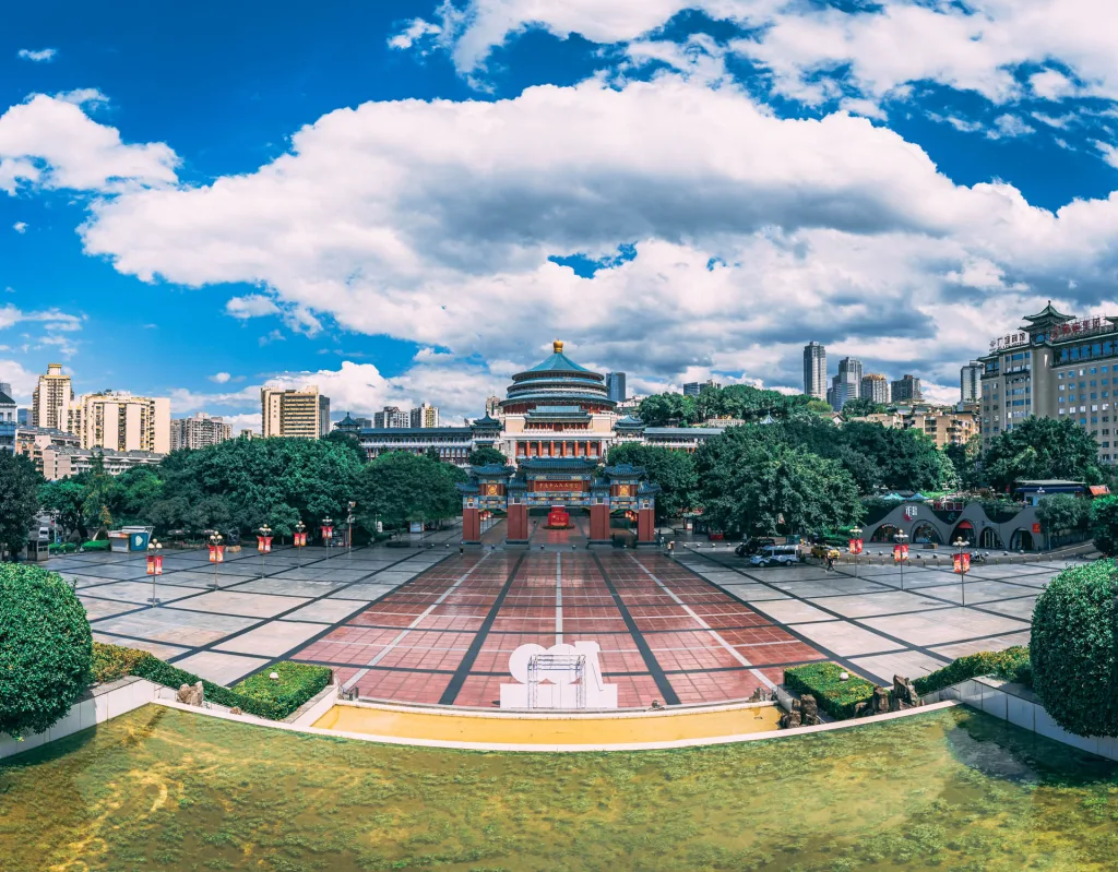 The Great Hall of the People in Chongqing beneath a bright blue sky