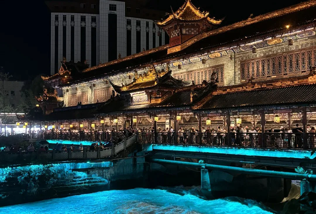 Nanqiao Bridge and its blue-lit water at night in Dujiangyan