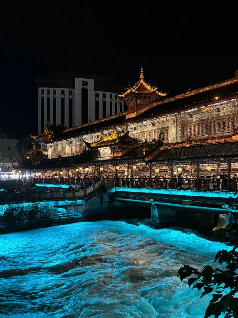 Nanqiao Bridge and its blue-lit water at night in Dujiangyan