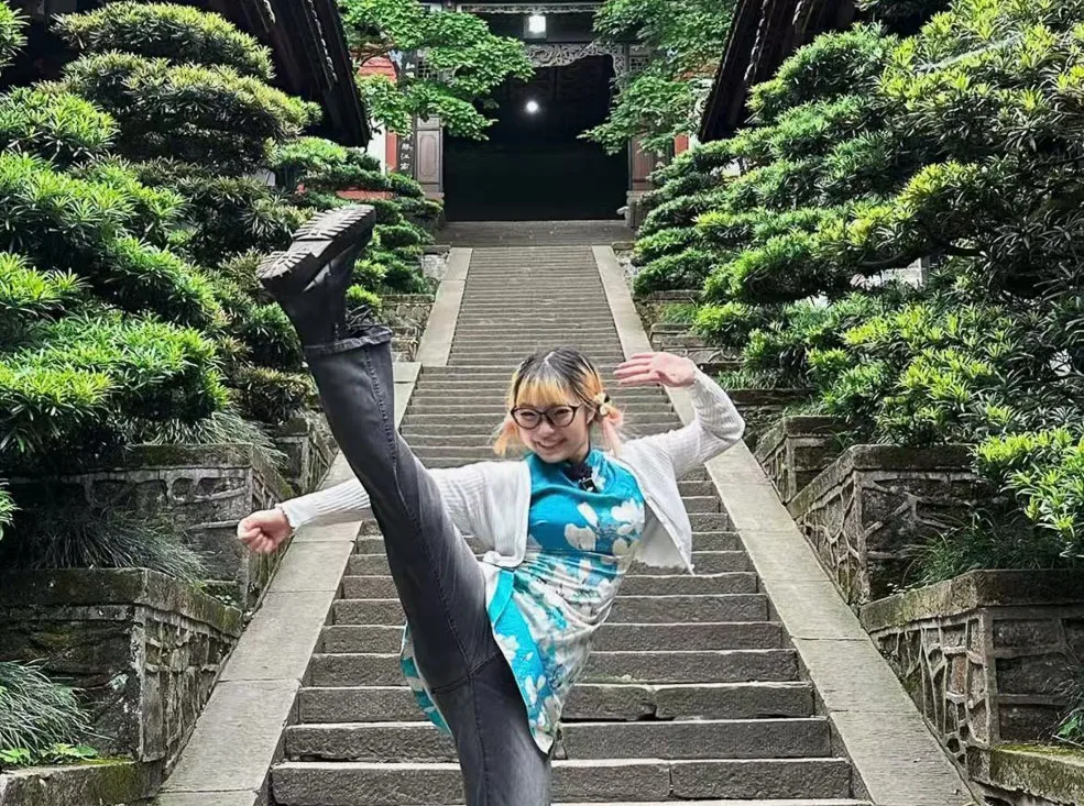 A guest learning a Tai Chi movement from a local master