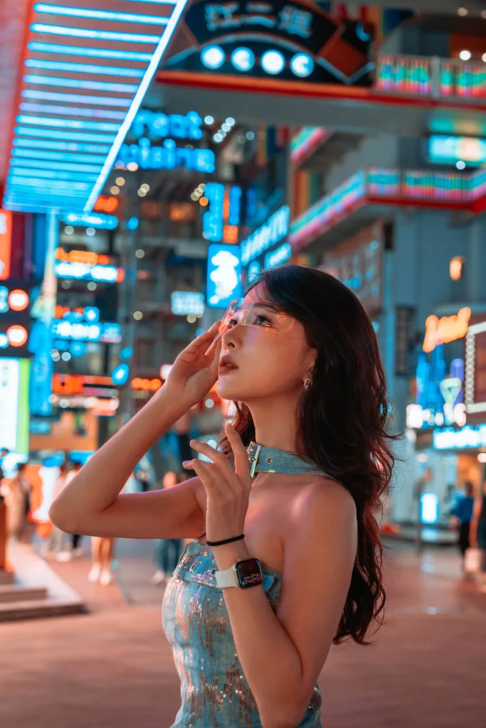 Traveler posing for a cyberpunk night portrait beneath neon lights in Chongqing