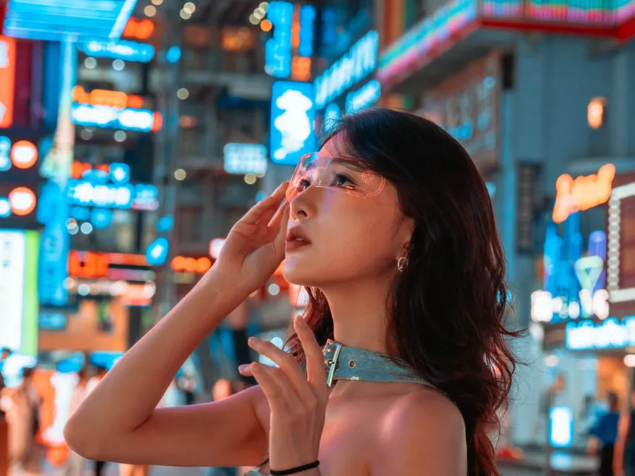 Traveler posing for a cyberpunk night portrait beneath neon lights in Chongqing