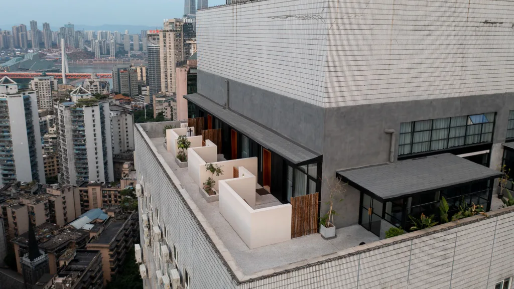 Aerial view of SOMMET Rooftop Hotel and its terraces above central Chongqing