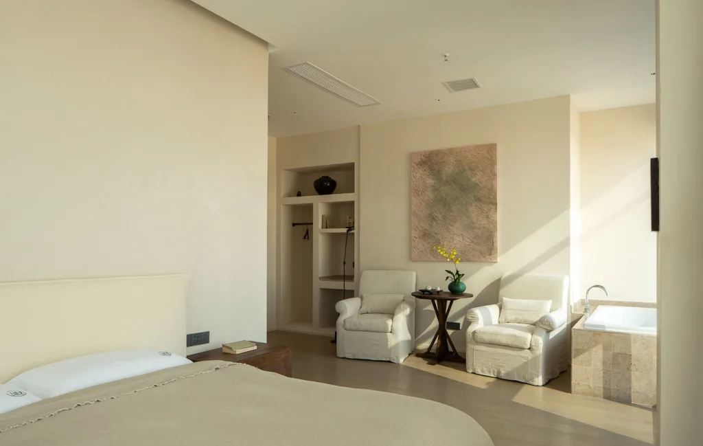 Spacious guest room with natural finishes and warm afternoon light
